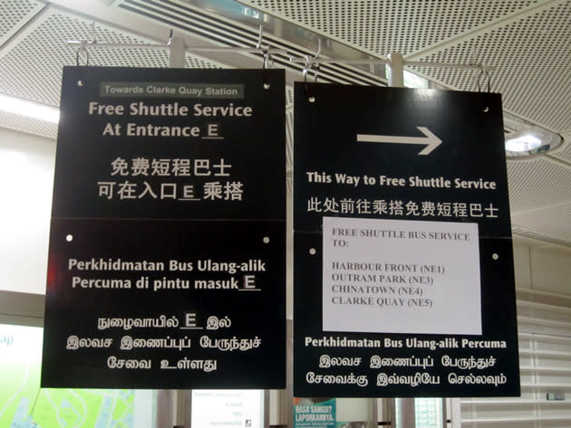 A sign inside Dhoby Ghaut's North East Line station provides directions to the free shuttle buses available. (Yahoo! photo/Jeanette Tan)