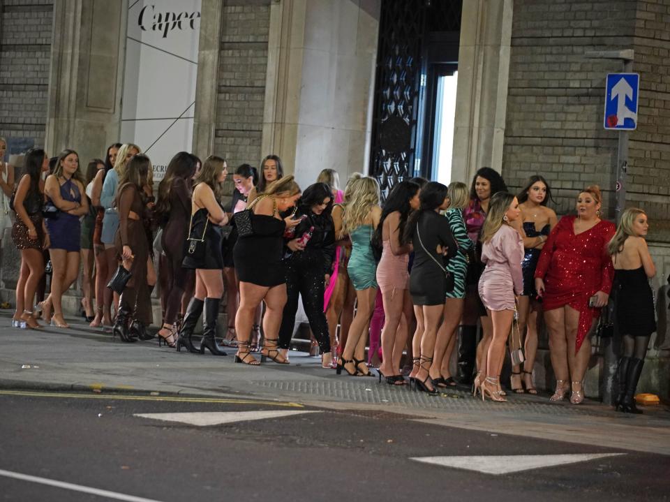 People stand in line for entry to a nightclub in the centre of Liverpool (PA)