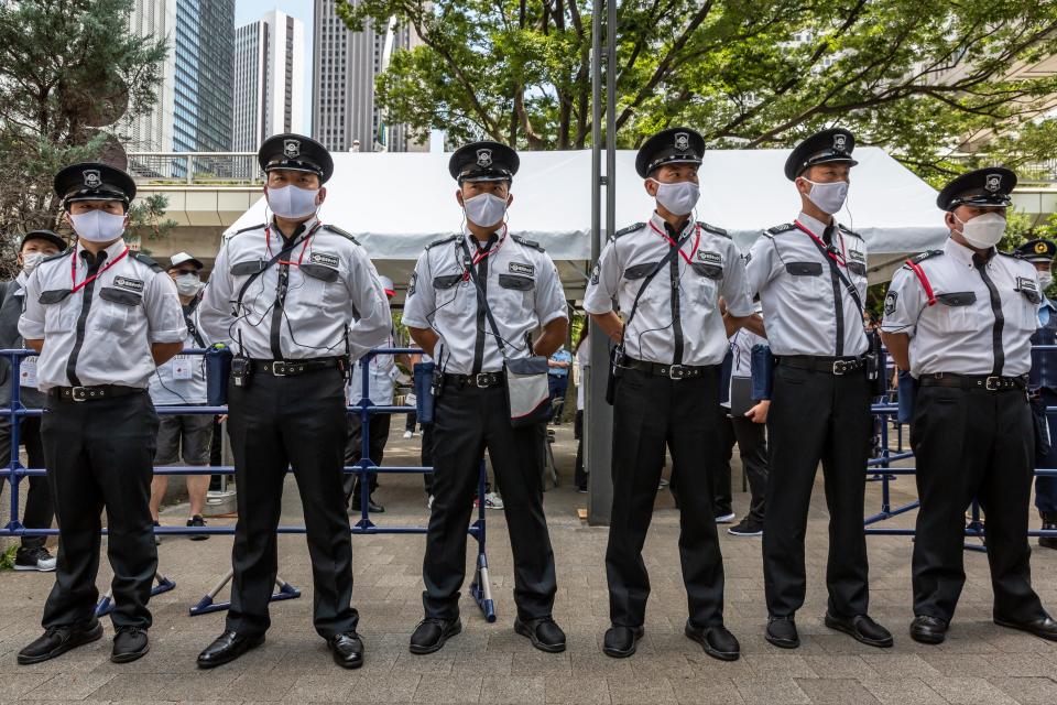 Security guards protect the Olympic Torch Relay Celebration event venue (Getty Images)