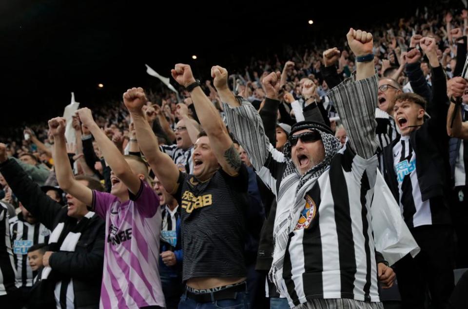 Newcastle fans dressed in homage to the club’s new owners in the Gallowgate End celebrate as their team scores against Tottenham at St James’ Park. Tottenham won 3-2