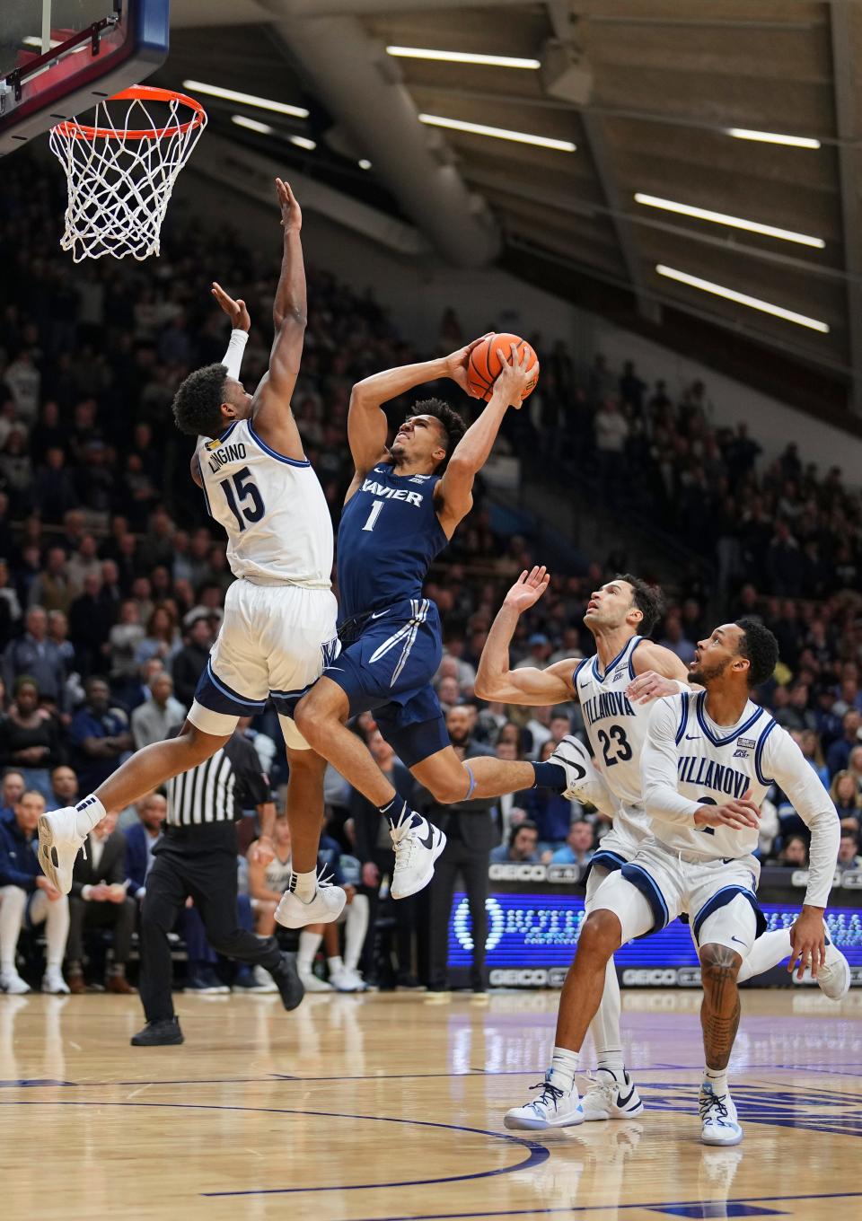 VILLANOVA, PENNSYLVANIA - JANUARY 3: Desmond Claude #1 of the Xavier Musketeers shoots the ball against Jordan Longino #15 of the Villanova Wildcats in the first half at Finneran Pavilion on January 3, 2024 in Villanova, Pennsylvania.