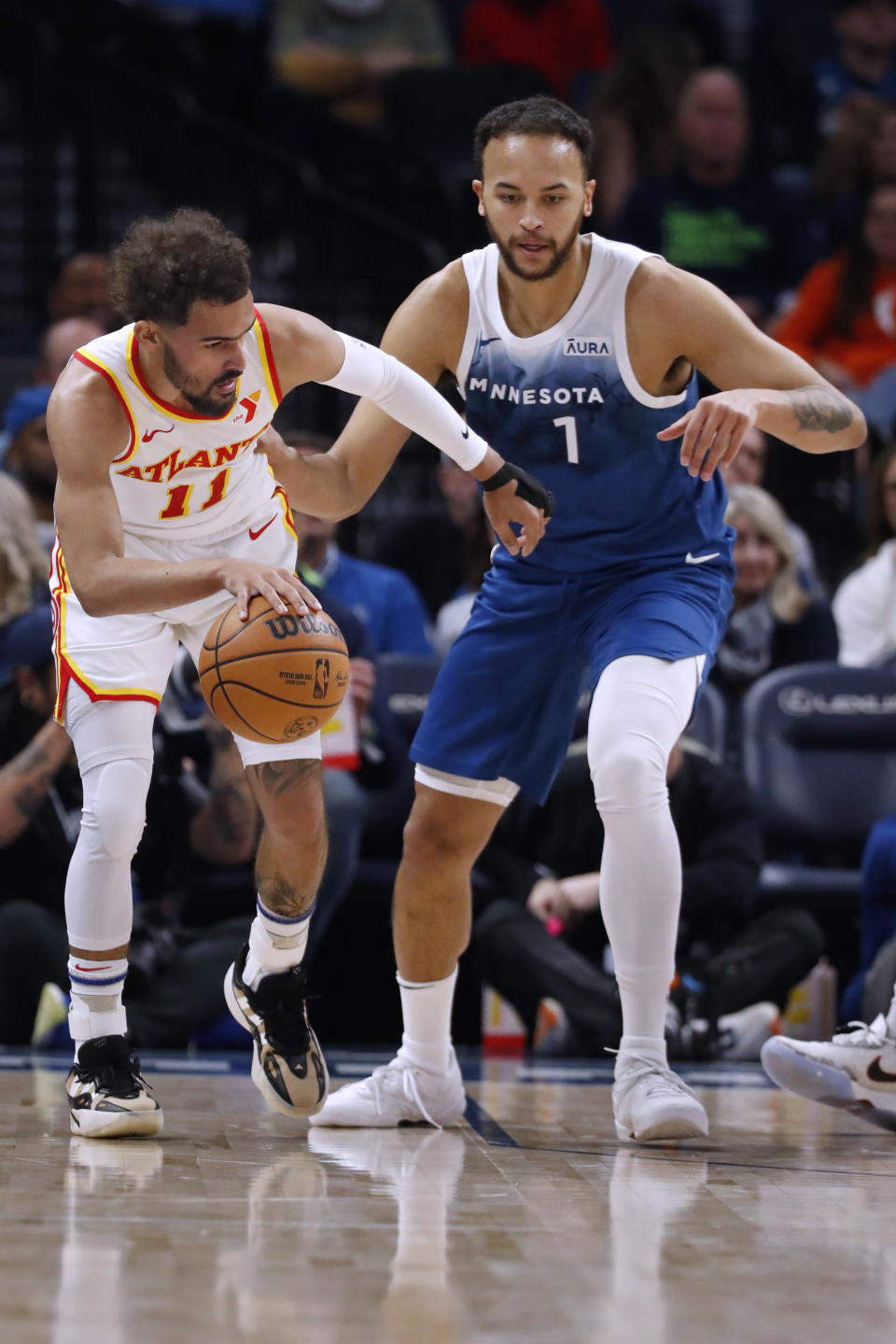 Atlanta Hawks guard Trae Young (11) works around Minnesota Timberwolves forward Kyle Anderson (1) in the second quarter of an NBA basketball game Friday, April 12, 2024, in Minneapolis. (AP Photo/Bruce Kluckhohn)