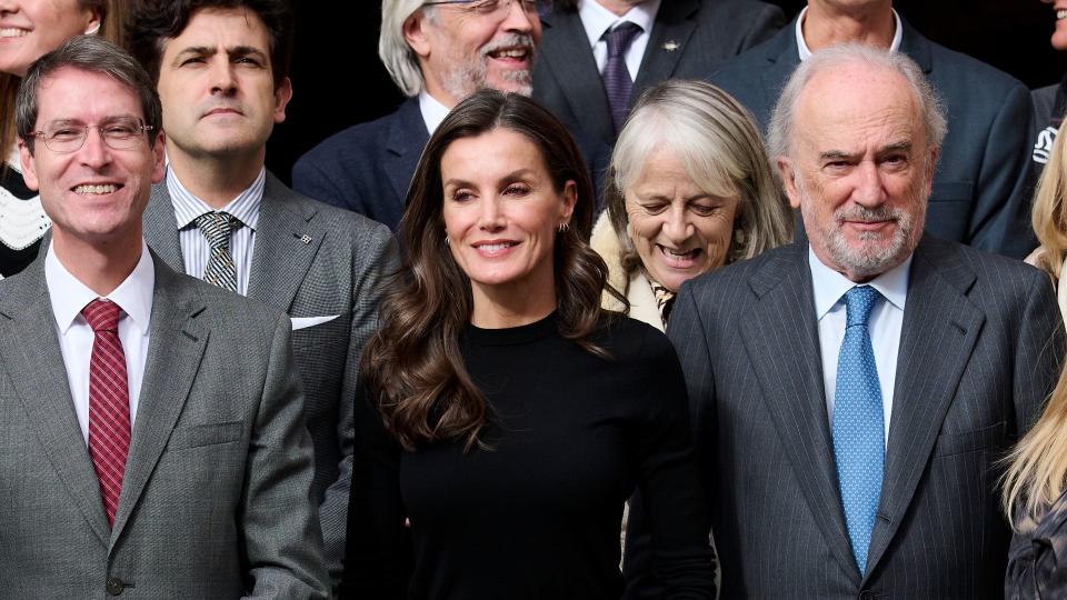 Queen Letizia Letizia in check trousers and black top and leather jacket