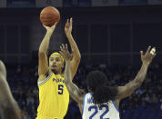 Michigan Wolverines' Terrance Williams II (5) shoots as Kentucky Wildcats' Cason Wallace (22) defends during an NCAA basketball game between Michigan Wolverines and Kentucky Wildcats at the O2 Arena, in London, Sunday, Dec.4, 2022. (AP Photo/Ian Walton)