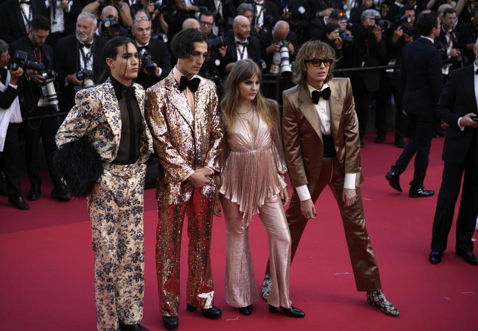 Ethan Torchio, from left, Damiano David, Victoria De Angelis, and Thomas Raggi of Maneskin pose for photographers upon arrival at the premiere of the film 'Elvis' at the 75th international film festival, Cannes, southern France, Wednesday, May 25, 2022. (AP Photo/Daniel Cole)