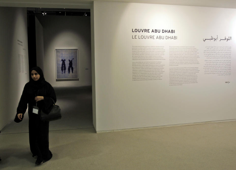 An Emirati visitor passes in front of "Anthropometry" by French artist Yves Klein which is part of a sample collection at the Abu Dhabi branch of the Louvre in Abu Dhabi, United Arab Emirates, Tuesday, April 16, 2013. No artistic subjects will be off limits at the Abu Dhabi branch of the Louvre museum as it builds its collection for a planned 2015 opening, a top overseer said Tuesday, in a city seeking to broaden its international profile but testing how far to open its conservative culture. (AP Photo/Kamran Jebreili)