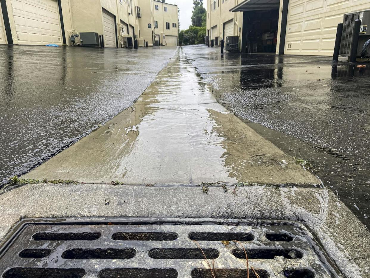 Water runs into a storm drain in a Los Angeles alley on Aug. 19, 2023, during Tropical Storm Hilary. <a href="https://www.gettyimages.com/detail/news-photo/storm-drain-in-alley-in-apartment-complex-during-tropical-news-photo/1646723445" rel="nofollow noopener" target="_blank" data-ylk="slk:Citizen of the Planet/Universal Images Group via Getty Images;elm:context_link;itc:0;sec:content-canvas" class="link ">Citizen of the Planet/Universal Images Group via Getty Images</a>