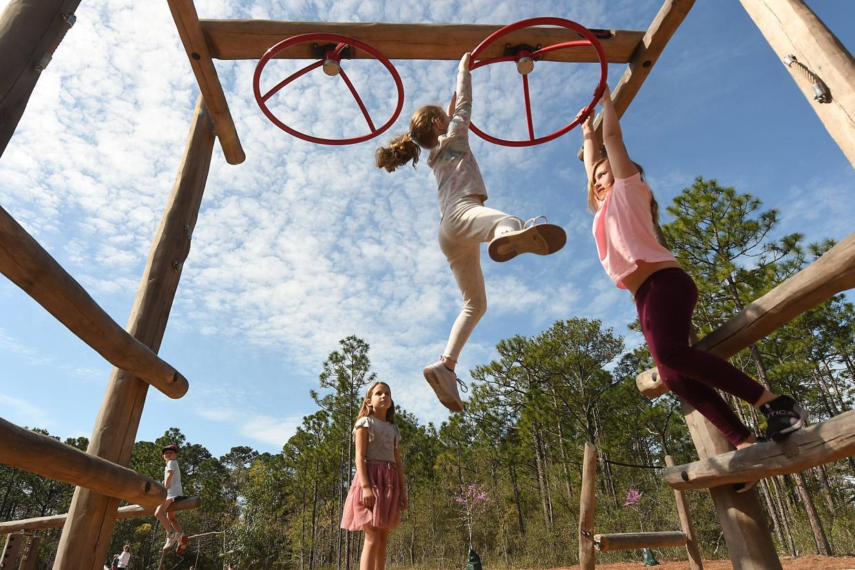 Kids play at a playground in Hanover Pines Nature Park off Carolina Beach Road Match 18, 2024, in Wilmington.