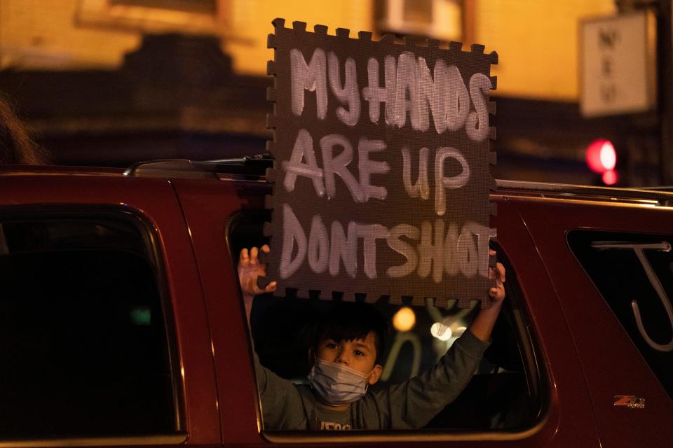 Protesters block an intersection following a march for 13-year-old Adam Toledo Friday April 15, 2021 in Chicago's Logan Square neighborhood.