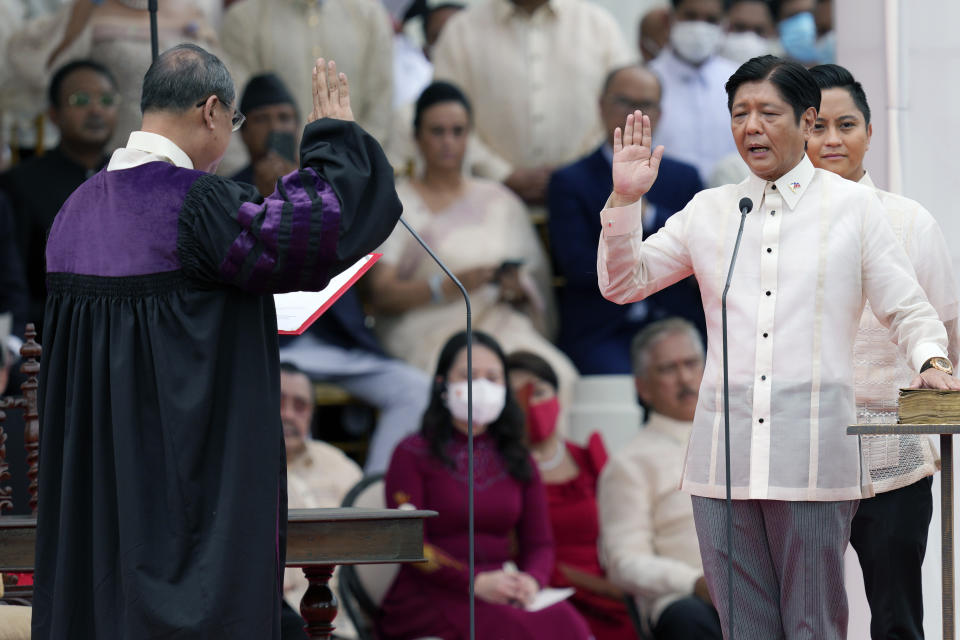 President-elect Ferdinand "Bongbong" Marcos Jr., right, is sworn in by Supreme Court Chief Justice Alexander Gesmundo during the inauguration ceremony at National Museum on Thursday, June 30, 2022 in Manila, Philippines. Marcos was sworn in as the country's 17th president. (AP Photo/Aaron Favila)