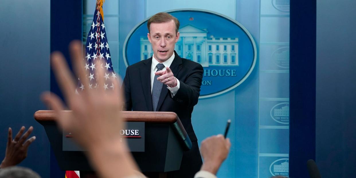 Jake Sullivan stands at a White House podium, pointing at a reporter's raised hand