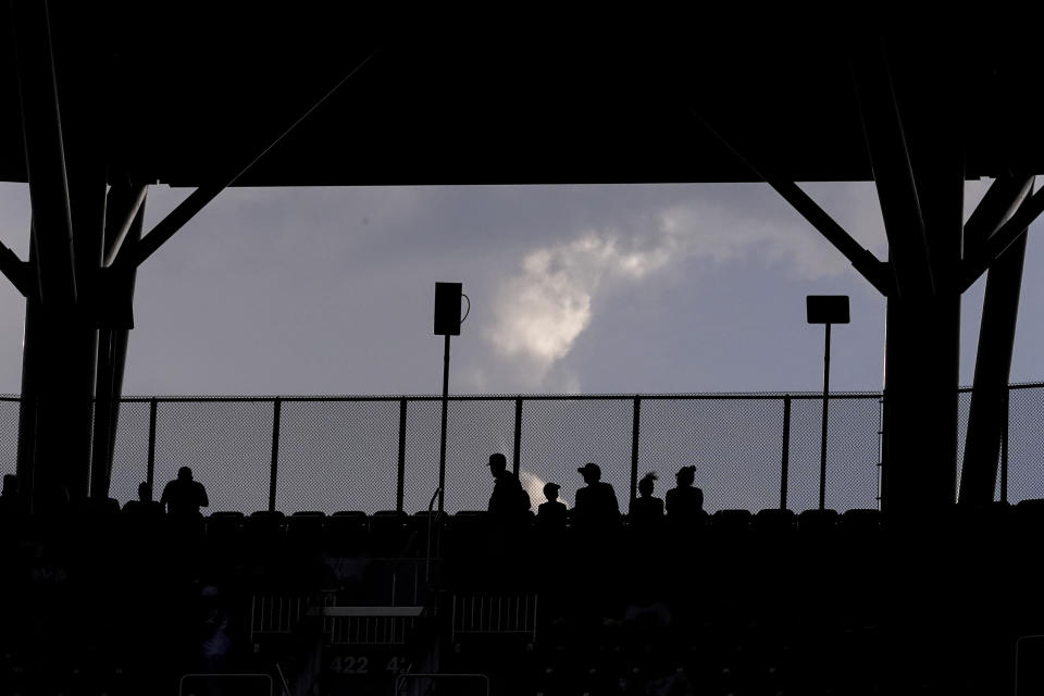 Fans wait for a baseball game between the St. Louis Cardinals and the Atlanta Braves on Tuesday, July 5, 2022, in Atlanta. (AP Photo/Brynn Anderson)