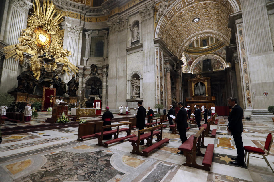 Pope Francis presides over a solemn Easter vigil ceremony in St. Peter's Basilica empty of the faithful following Italy’s ban on gatherings to contain coronavirus contagion, at the Vatican, Saturday, April 11, 2020. The new coronavirus causes mild or moderate symptoms for most people, but for some, especially older adults and people with existing health problems, it can cause more severe illness or death. (Remo Casilli/Pool Photo via AP)