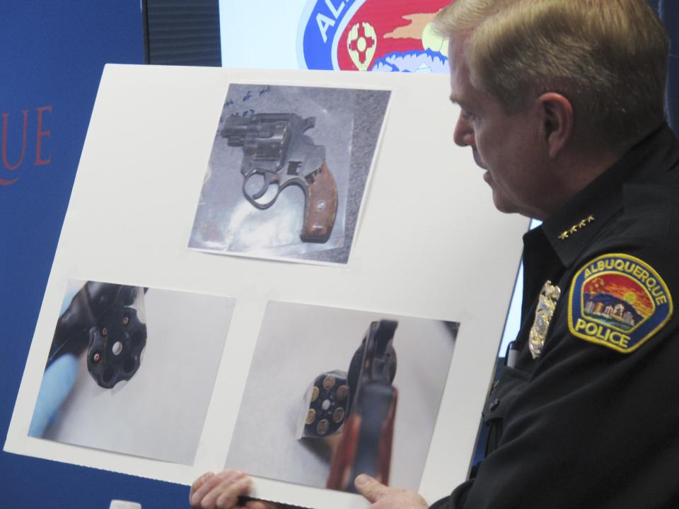 Albuquerque Police Chief Gorden Eden discusses a gun found on a man shot by police during a news conference, Wednesday, March 26, 2014, at Albuquerque Police headquarters in Albuquerque, N.M. The Albuquerque Police Department came under new scrutiny after officers shot and killed Alfred Redwine, 30, outside a public housing complex in the second deadly encounter in the last 10 days. Eden said Redwine fired at officers and police returned fire. However, Redwine's family said that Redwine was not armed and only had a cellphone in his hand. (AP Photo/Russell Contreras)