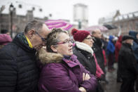 Residents react during gathering being held in a central square of the eastern French city of Strasbourg, Sunday Dec.16, 2018 to pay homage to the victims of a gunman who killed four people and wounded a dozen more. The gathering was held in Kleber Square by a Christmas market and near where the gunman opened fire last Tuesday evening. (AP Photo/Jean-Francois Badias)