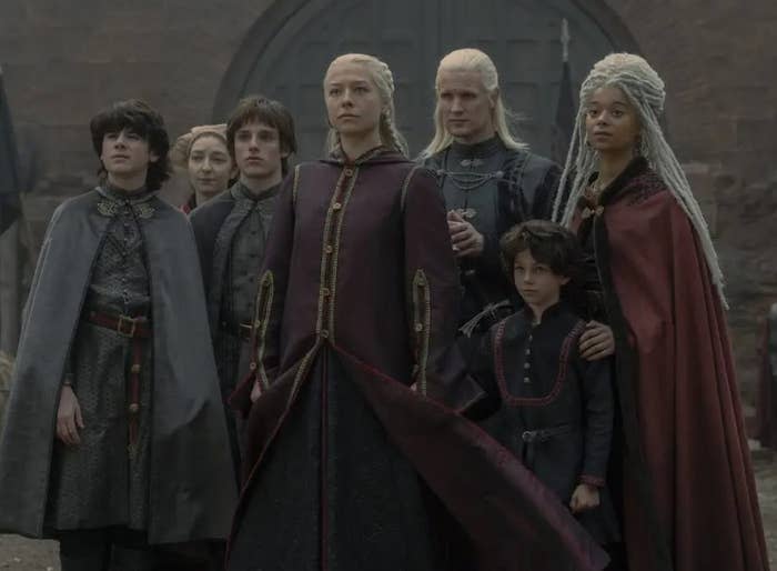 Rhaenyra stands with her family in front of the gate to the Red Keep