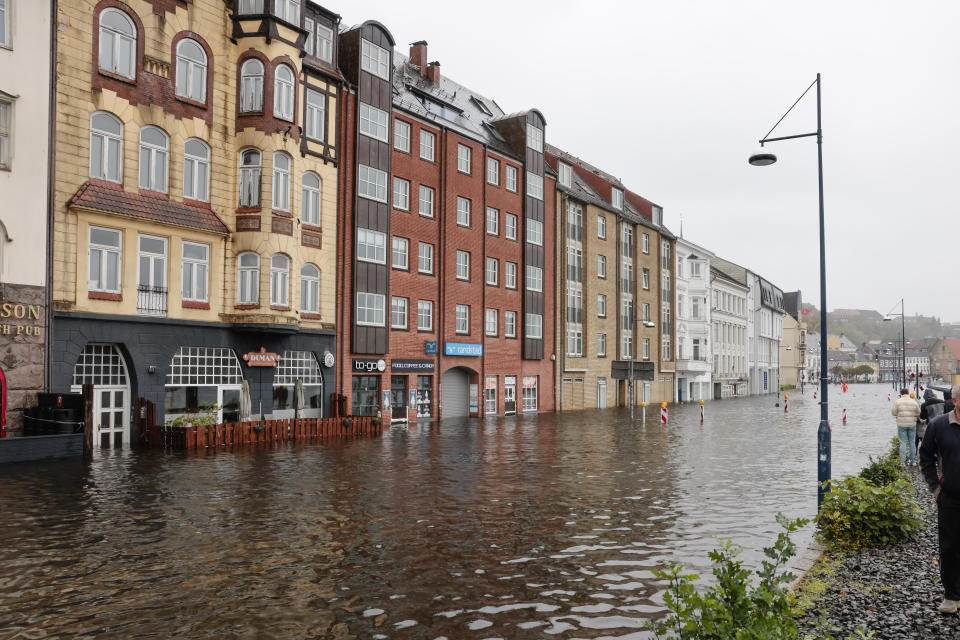 Water flooded a street in the city center in Flensburg, Germany, Friday, Oct. 20, 2023. A powerful storm pushes the Baltic Sea water ashore and causes flooding in Schleswig-Holstein. In Flensburg, it could be the highest storm surge in 100 years. (Frank Molter/dpa via AP)