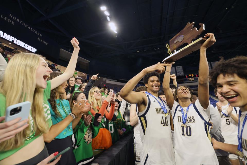 Archbishop Williams players celebrate with the student body at the conclusion of their MIAA Division 3 title game versus St. Mary's at the Tsongas Center in Lowell on Saturday, March 18, 2023.     