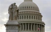 The U.S. Capitol dome is seen behind a statue on Capitol Hill in Washington after the U.S. government shutdown, October 1, 2013. REUTERS/Larry Downing