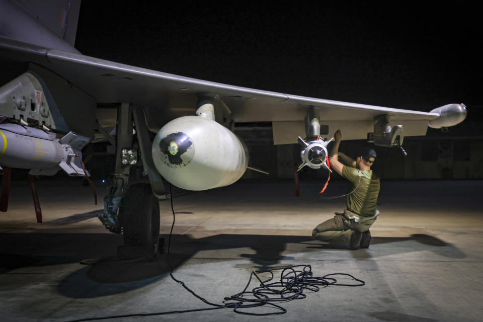 In this image provided by the UK Ministry of Defence, RAF Armourers (Weapon Technicians) prepare a Royal Air Force Typhoon FGR4 for air strikes against Houthi military targets in Yemen, in RAF Akrotiri, Sunday, Jan. 21, 2024. The U.S. and British militaries bombed eight locations used by the Iranian-backed Houthis in Yemen on Monday night, the second time the two allies have conducted coordinated retaliatory strikes on an array of the rebels' missile-launching capabilities. (AS1 Leah Jones/Ministry of Defence via AP)