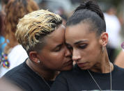 <p>Angel Ayala (L) and Carla Montanez hug as they mourn the loss of their best friend in the mass shooting at the Pulse gay nightclub as people gather together outside the club during a one-year anniversary memorial service on June 12, 2017 in Orlando, Florida. (Joe Raedle/Getty Images) </p>