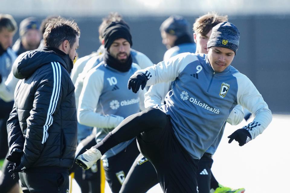 Crew forward Cucho Hernandez stretches during preseason training.