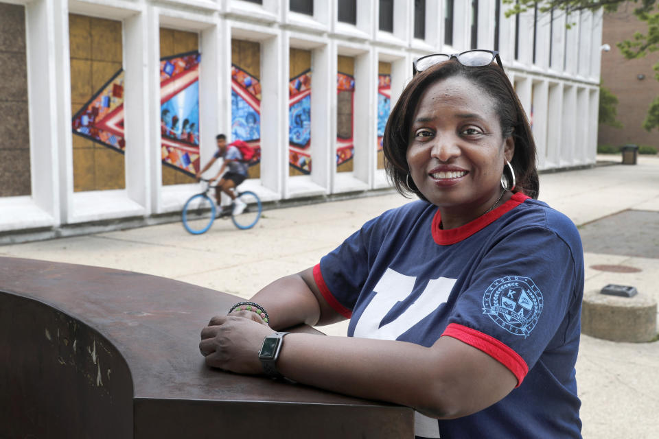 Karen Calloway, principal of Kenwood Academy in Chicago, poses Tuesday, July 28, 2020, for a portrait outside the Hyde Park neighborhood campus. School districts around the U.S. are working to remove police officers from campuses, but the school council for Kenwood Academy, a predominantly Black school near the University of Chicago, recently unanimously voted to keep its officer. (AP Photo/Charles Rex Arbogast)