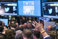 A trader raises his hand just before the Twitter Inc. IPO begins on the floor of the New York Stock Exchange in New York, November 7, 2013. REUTERS/Lucas Jackson