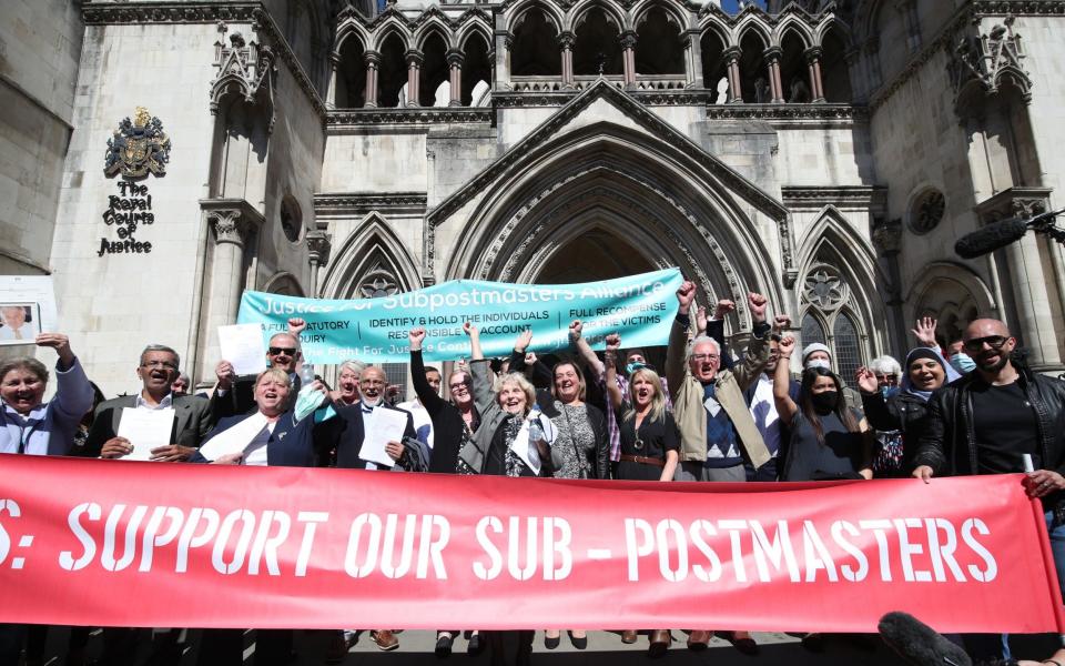 Former post office workers celebrating outside the Royal Courts of Justice, London - Yui Mok/PA Wire