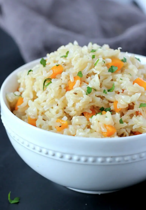 <p>Garden in the Kitchen</p><p>Brown rice sautéed with fresh pressed garlic and onion in oil to lock in the flavors. Simply an irresistible side dish to complete (and complement) all your meals!</p><p><strong>Get the recipe: <a href="https://gardeninthekitchen.com/garlicky-carrot-brown-rice/" rel="nofollow noopener" target="_blank" data-ylk="slk:Garlicky Carrot Brown Rice;elm:context_link;itc:0;sec:content-canvas" class="link rapid-noclick-resp">Garlicky Carrot Brown Rice</a></strong></p>