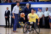 Canada's Prime Minister Justin Trudeau (L) and Britain's Prime Minister Theresa May (C) watch Steve Arnold, Britain's vice-captain for the Invictus Games, during an event at Lisgar Collegiate Institute in Ottawa, Ontario, Canada, September 18, 2017. REUTERS/Chris Wattie