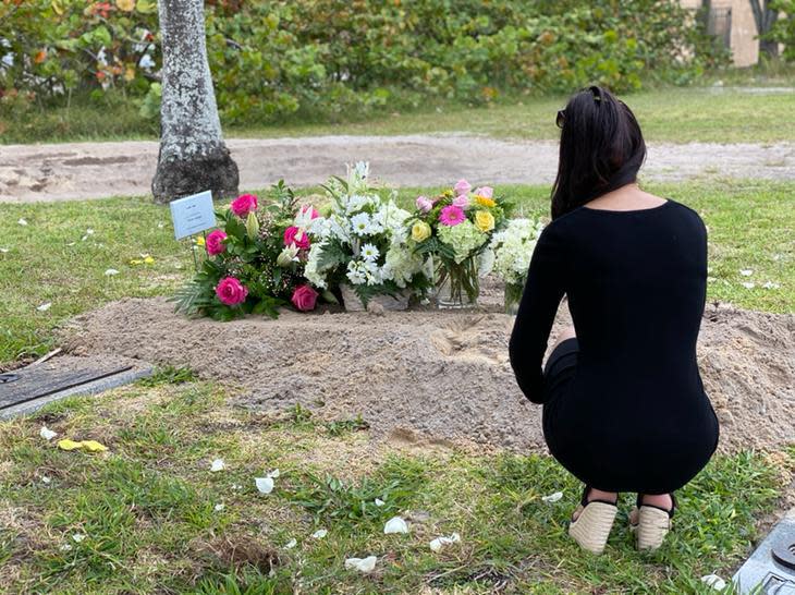 Deniz Killic squats down next to her mother's graveside after her burial on April 5 near Lantana. Azade "Azzie" Kilic, of Queens, NY, died from COVID-19 on April 2 in Delray Beach.