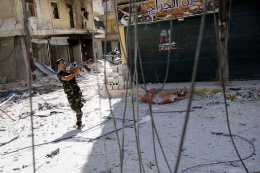 A Syrian rebel aims his weapon as he tries to dodge pro-government sniper fire while running across a street in the Salaheddin district of the northern city of Aleppo on August 13, 2012. Syrian rebels claimed they downed a fighter jet in what would be a major coup for the opposition but the regime seized the upper hand in Aleppo as it advanced into a new rebel-held district