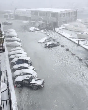 Cars are seen on a flooded street in Boston, Massachusetts, U.S., in this still image taken from a January 4, 2018 social media video. INSTAGRAM/@DOILOVEYOU/via REUTERS