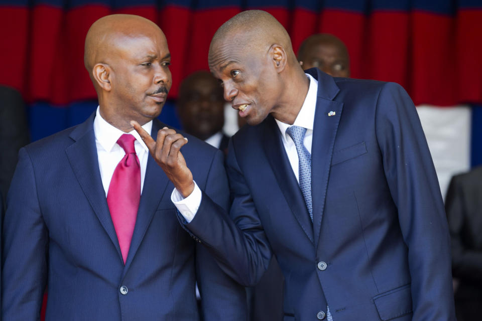 Haiti's President Jovenel Moise, right, talks with resigning prime minister Jean Michel Lapin, at the national palace during a ceremony marking the 216th anniversary of Battle of Vertieres in Port-au-Prince, Haiti, Monday, Nov. 18, 2019. The battle was the last major battle of Haitian independence from France. (AP Photo/Dieu Nalio Chery)