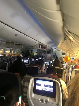 Passengers of the Air Canada AC 33 flight, which diverted to Hawaii after turbulence, are seen inside the plane at Honolulu airport