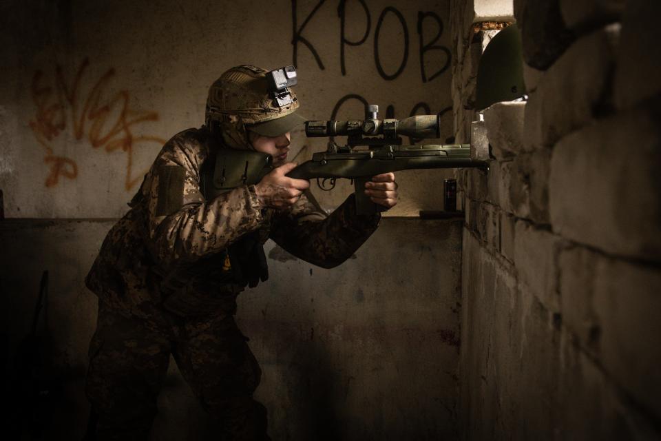 A member of the foreign legion searches for Russian positions with a sniper rifle on the east bank of the Dnipro River in Kherson (Getty Images)