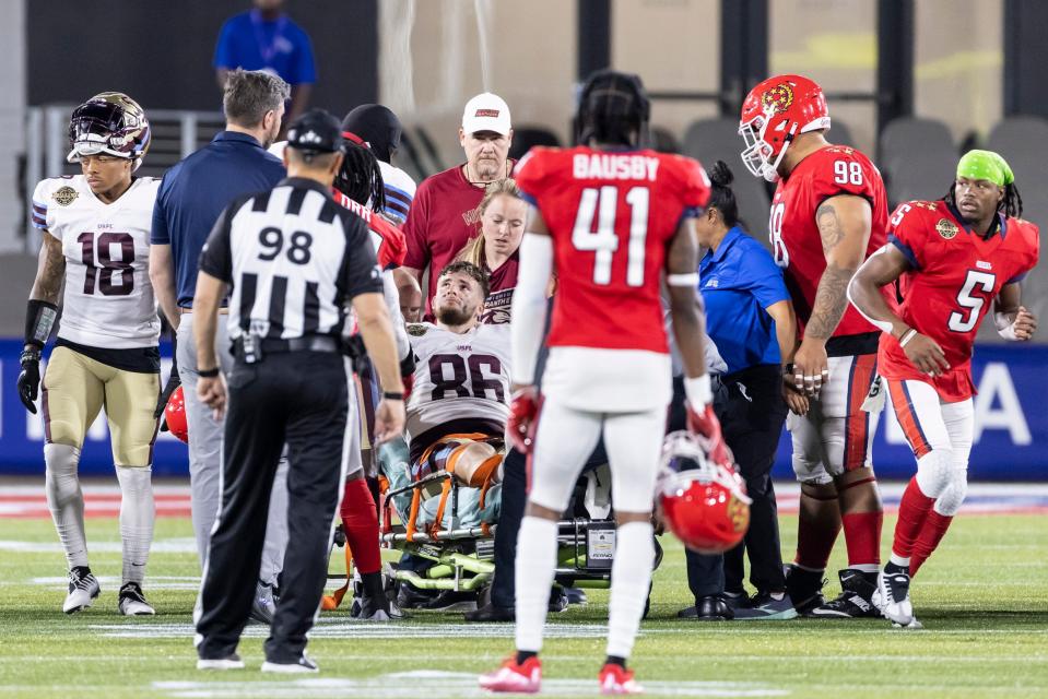 New Jersey Generals players shake hands with Michigan Panthers tight end Joseph Magnifico (86) as he is carted off the field in the first half at Protective Stadium.