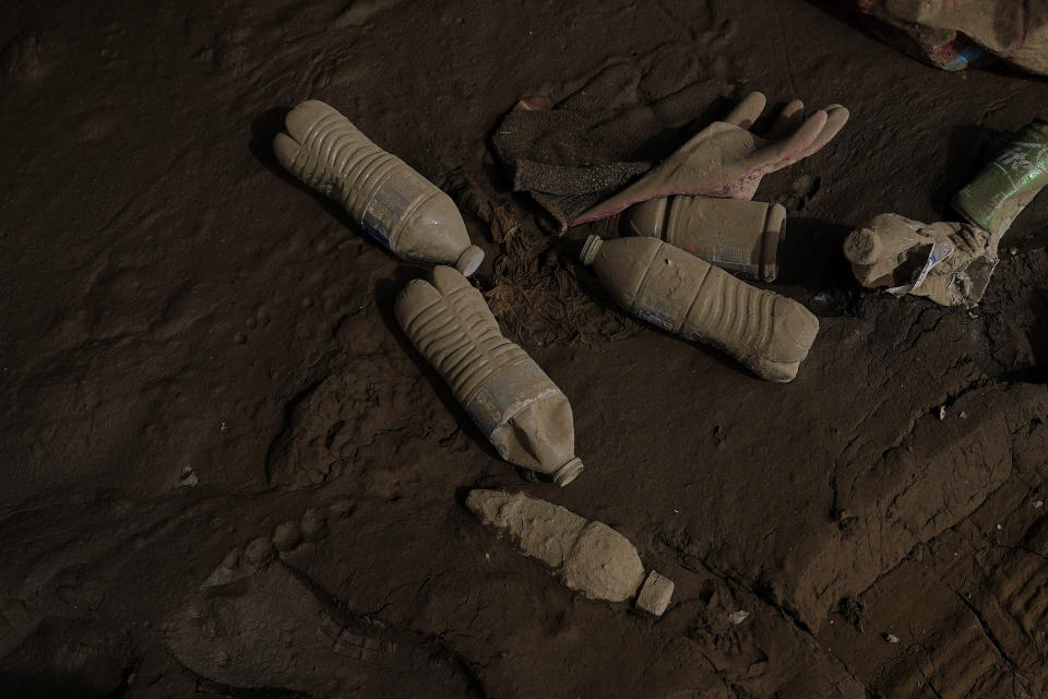 Mud covers water bottles on Friday, Aug. 5, 2022, in Fleming-Neon, Ky. (AP Photo/Brynn Anderson)