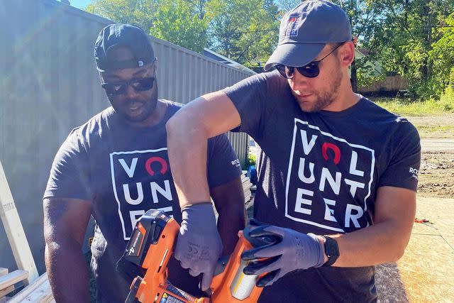 <p>Rocket Co</p> Rocket team members repair homes at a volunteer event.