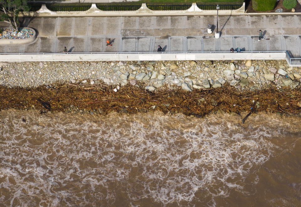 Debris lines the shore brought in by brown waves at Surfers Point at Seaside Park on Jan. 10, 2023, in Ventura, California.