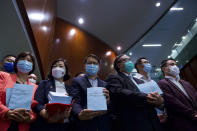 Pro-China lawmakers pose to reporters after attending the first and second reading of "Improving Electoral System (Consolidated Amendments) Bill 2021" at the Legislative Council in Hong Kong, Wednesday, April 14, 2021. Hong Kong’s electoral reform bill was introduced in the city’s legislature on Wednesday, setting in motion changes that will give Beijing greater control over the process while reducing the number of directly elected representatives. (AP Photo/Vincent Yu)