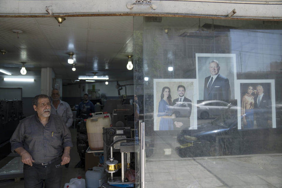 Posters with pictures of, from left, Saudi architect Rajwa Alseif, Crown Prince Hussein, King Abdullah II and Queen Rania, iare pasted at the entrance of a print house in the capital Amman, Jordan, Wednesday, May 31, 2023. Crown Prince Hussein and Saudi architect Rajwa Alseif are to be married on Thursday at a palace wedding in Jordan, a Western-allied monarchy that has been a bastion of stability for decades as Middle East turmoil has lapped at its borders. (AP Photo/Nasser Nasser)