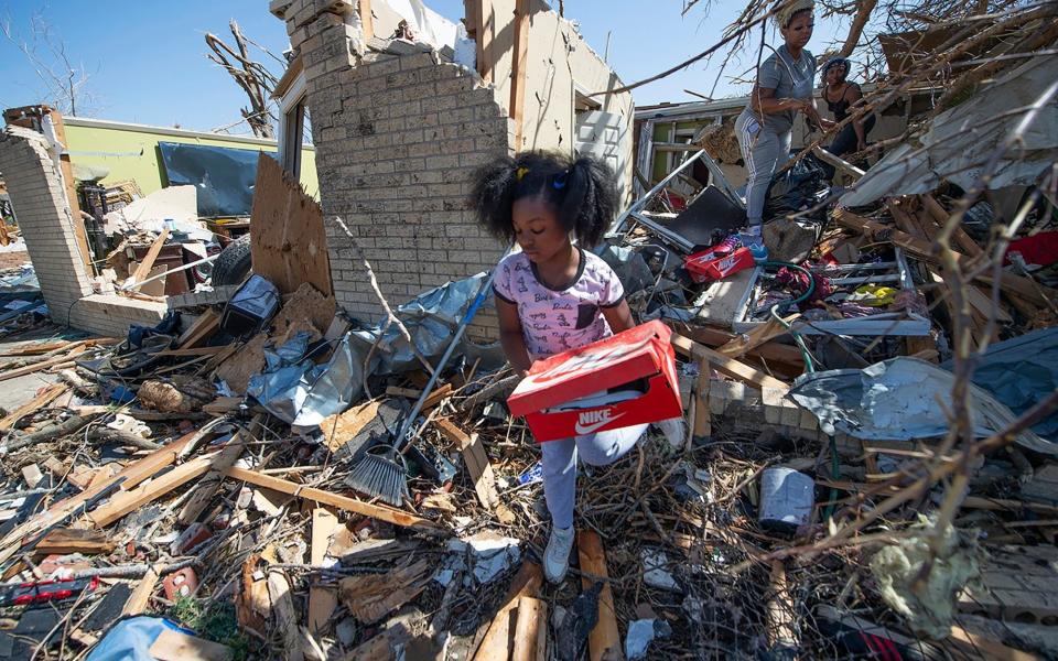 Family members salvage what they can from their destroyed home in Rolling Fork, Mississippi - Barbara Gauntt/AP