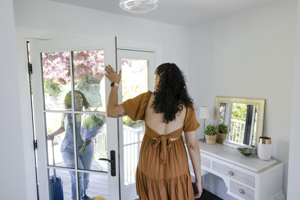 person letting their friend into their home