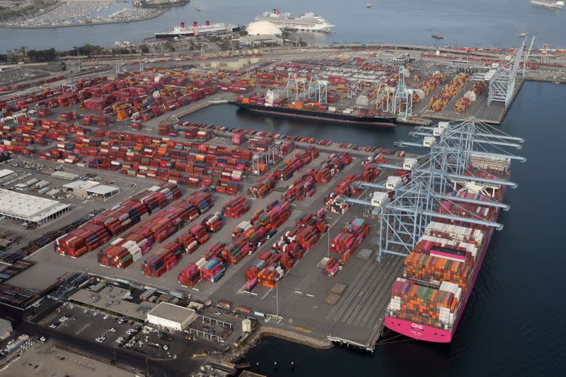 FILE PHOTO: Shipping containers are unloaded from ships at a container terminal at the Port of Long Beach-Port of Los Angeles complex, amid the coronavirus disease (COVID-19) pandemic, in Los Angeles