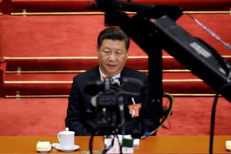 Camera is seen in front of China's President Xi Jinping attending the second plenary session of the National People's Congress (NPC) at the Great Hall of the People in Beijing, China March 8, 2017. REUTERS/Jason Lee