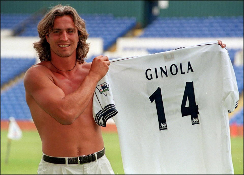 French soccer star David Ginola shows off 15 July, his new number 14 shirt that he will wear for his new club Tottenham Hotspur after signing for the London club for 2 million pounds from Newcastle United. (Photo by PAUL VICENTE / AFP)        (Photo credit should read PAUL VICENTE/AFP via Getty Images)