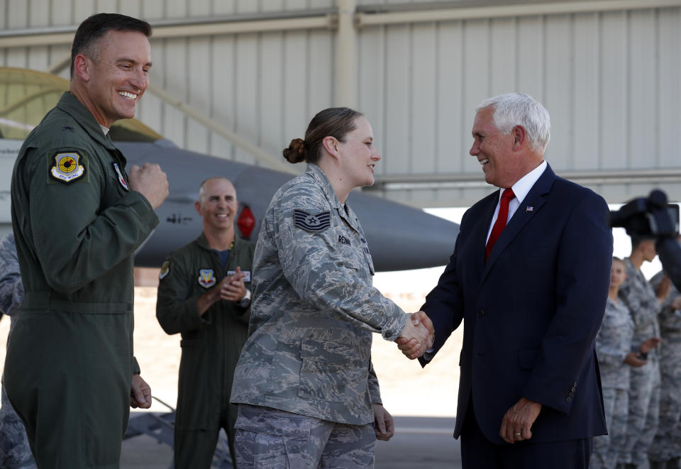 Staff Sgt. Vanessa Redman, center, thanks Vice President Mike Pence after being promoted to technical sergeant on Nellis Air Force Base flight line in Las Vegas, Friday, Sept. 7, 2018. Brigadier General Rob Novotny is at left. (Steve Marcus/Las Vegas Sun via AP)