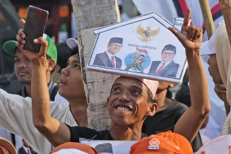 A supporter of presidential candidate Anies Baswedan and his running mate Muhaimin Iskandar cheers as he waits for the pair's arrival to register their names to run in next year's election at the General Election Commission building in Jakarta, Indonesia, Thursday, Oct. 19, 2023. Indonesia, the world's third-largest democracy, is set to vote in simultaneously legislative and presidential elections on Feb. 14, 2024. The country has had free and largely peaceful elections since the fall of dictator Suharto in 1998. (AP Photo/Achmad Ibrahim)